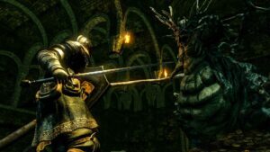 Knight battling a giant demon in Dark Souls (2011–2018, all versions).