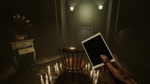 Player holding photo in candlelit room with empty chair and eerie atmosphere in MADiSON