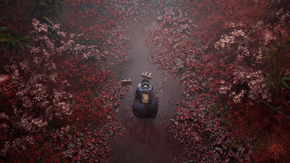 A girl kneeling among red flowers in Silent Hill f.