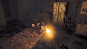 Player holding a torch to fend off mutant rats in a dimly lit room from Amnesia: The Bunker