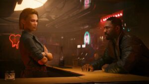 Two characters, V and Songbird, talk at a dimly lit bar surrounded by neon lights and holographic signs inside a nightclub in Cyberpunk 2077: Phantom Liberty.