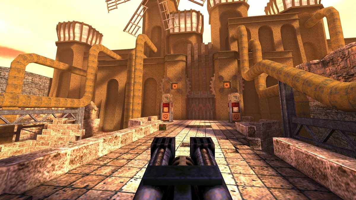 Gameplay from Quake II showing an industrial fortress with yellow pipes and windmills, a player aiming heavy weapons – explaining the boomer shooter genre.