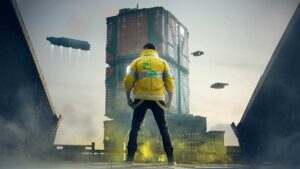 A character in a yellow jacket stands on a foggy rooftop facing a futuristic megastructure and flying vehicles in the distance in Cyberpunk 2077.