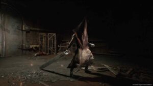 Pyramid Head from Silent Hill 2 Remake holding his massive Great Knife inside a dark industrial room.