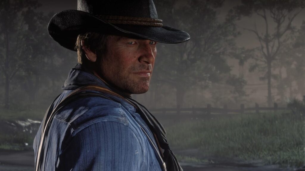 Arthur Morgan stares into the misty frontier in Red Dead Redemption 2, reflecting his rugged outlaw life