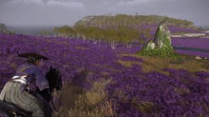 Atsu exploring a purple flower field on horseback in Ghost of Yotei’s open world