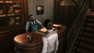 Kate Walker speaking with the innkeeper at the front desk in Syberia - Remastered