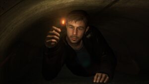 Heavy Rain – Ethan crawls through a dark tunnel, holding a lit match to find his way.